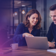 Two colleagues collaborating at a desk reviewing document management options, representing hybrid mail provider selection for UK organisations