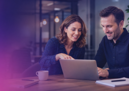 Two colleagues collaborating at a desk reviewing document management options, representing hybrid mail provider selection for UK organisations