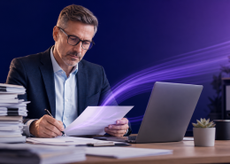 Business professional reviewing documents at a desk, representing document distribution services for UK organisations