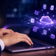 Hands typing on a laptop with digital document icons, representing electronic document distribution for UK businesses
