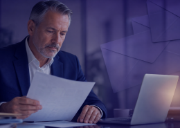 Pension administrator reviewing member communications at a desk, representing hybrid mail and digital document delivery for pension schemes