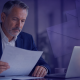 Pension administrator reviewing member communications at a desk, representing hybrid mail and digital document delivery for pension schemes